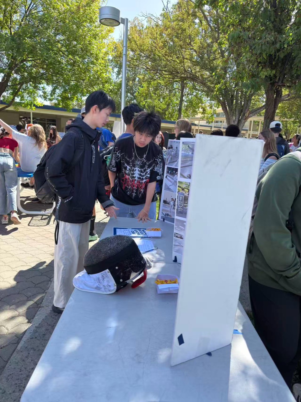 Club members helping students sign up at the Davis High School club fair