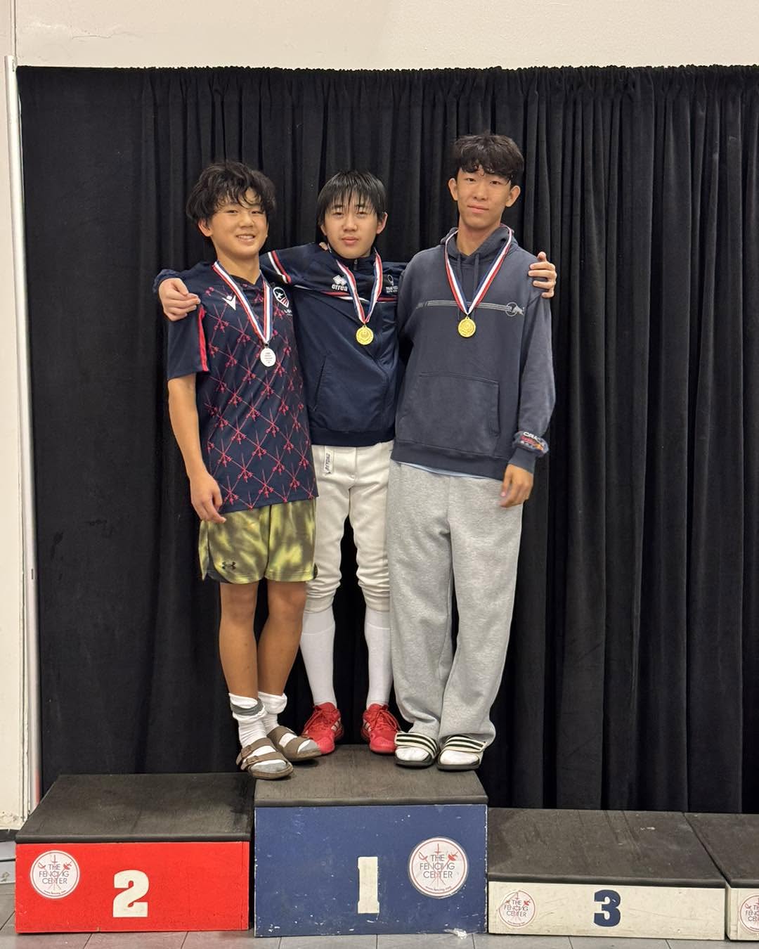Three teammates with medals at Cozmx RYC, from TFSA’s original report